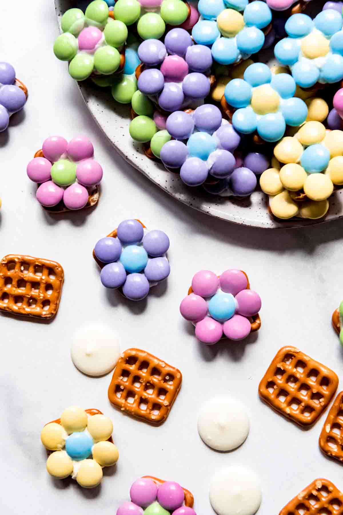 An up-close image of Easter candy "flowers" made with M&M's, white chocolate, and pretzels.