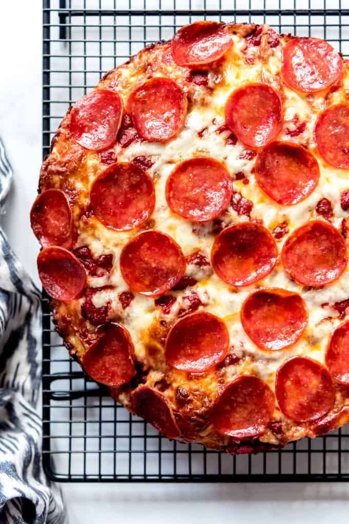 Deep dish pepperoni pizza on a wire rack.