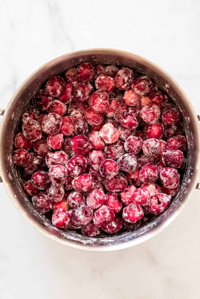 A large pot of fresh pitted cherries tossed with sugar and cornstarch.