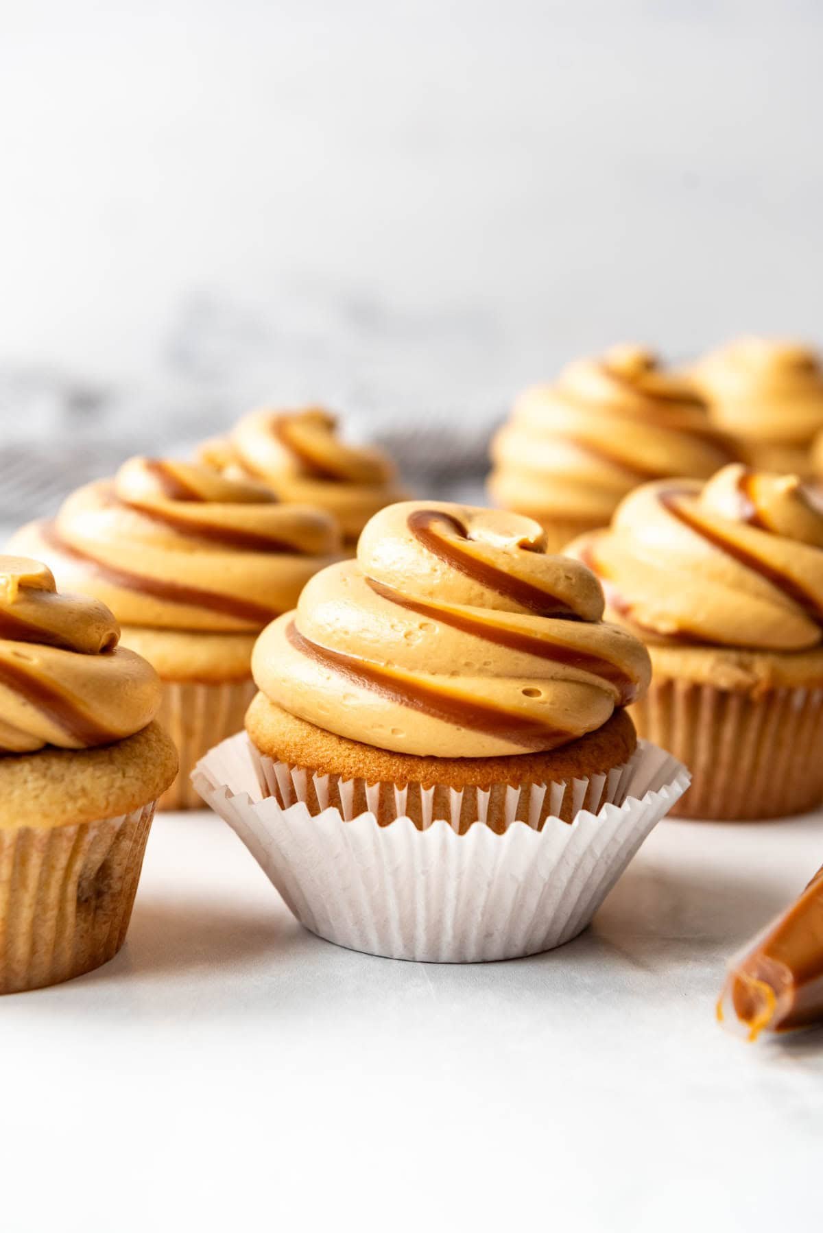 Cupcakes with frosting piped on top with swirls of dulce de leche.