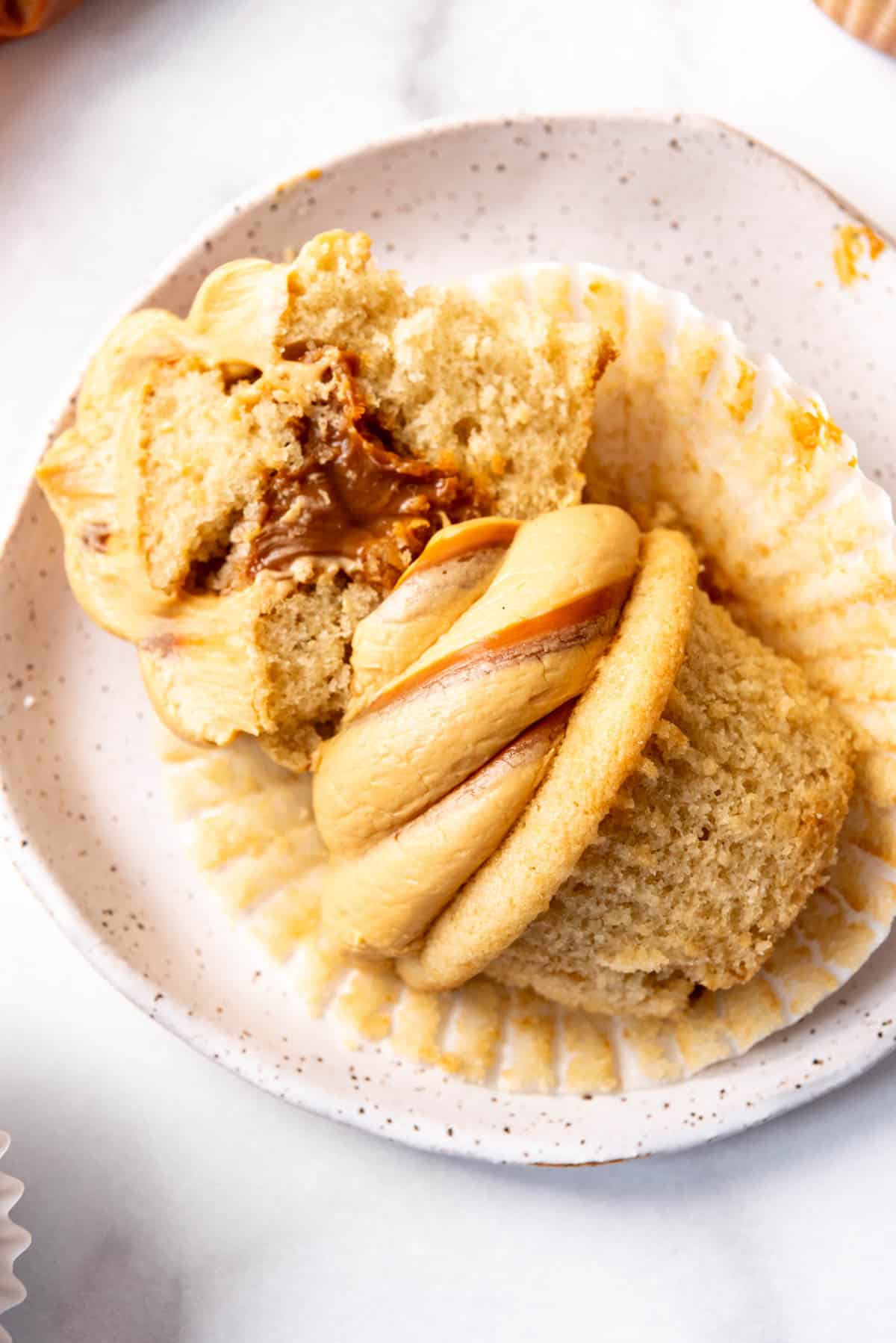 An overhead image of a dulce de leche cupcake on a plate.