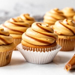 Cupcakes with frosting piped on top with swirls of dulce de leche.