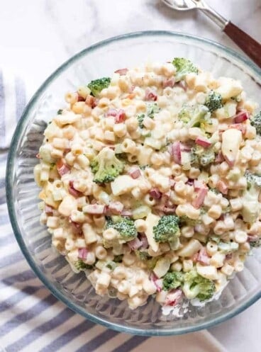 A glass bowl filled with macaroni salad.