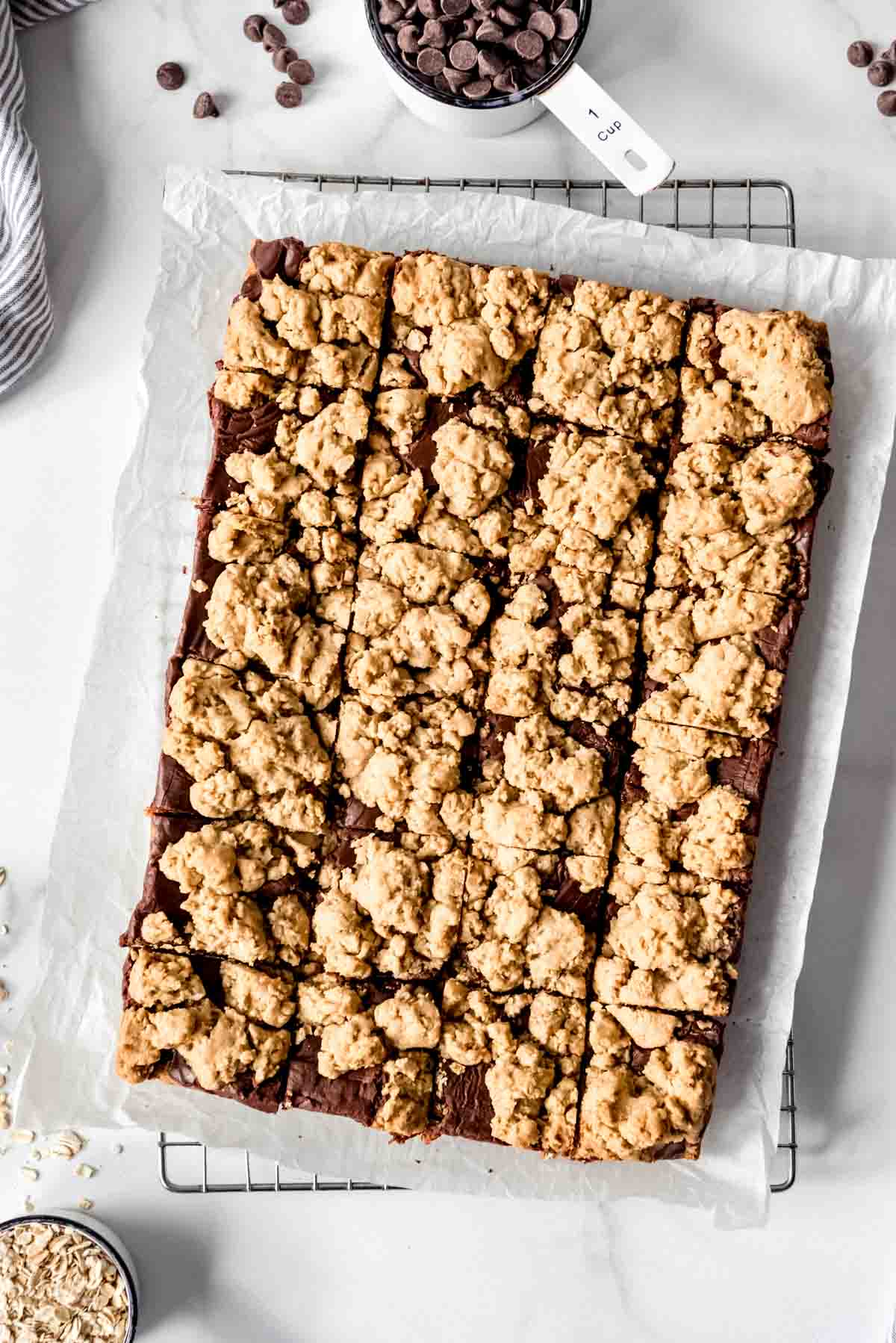 An overhead image of a batch of oatmeal fudge bars cut into squares.