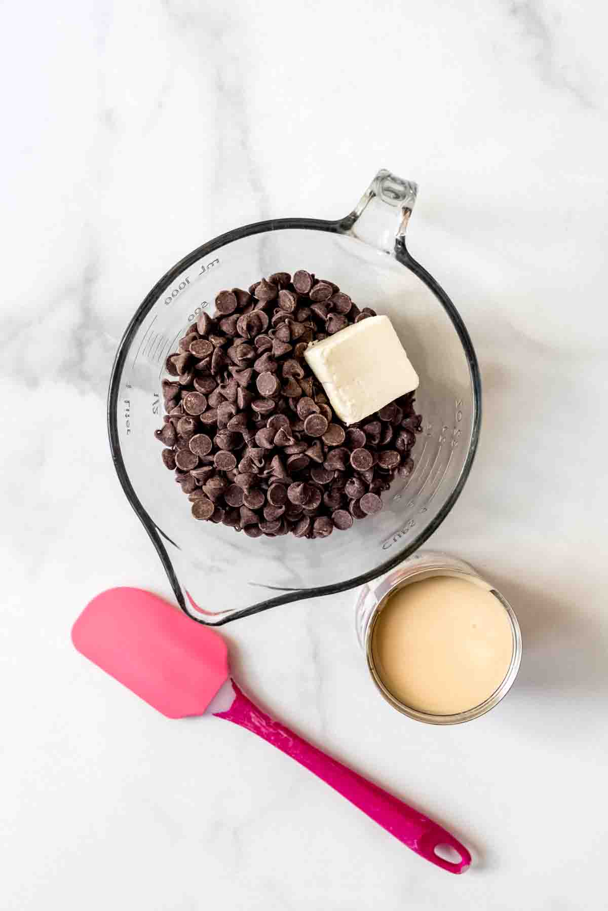 An image of semiweet chocolate chips, butter, and sweetened condensed milk.