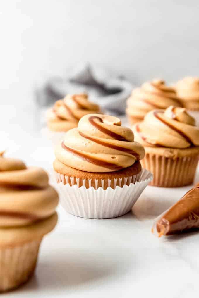 Cupcakes with frosting piped on top with swirls of dulce de leche.