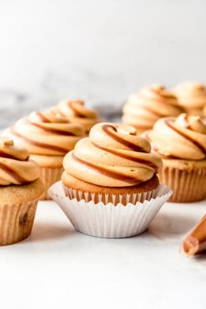 Dulce de leche cupcakes on a white surface.