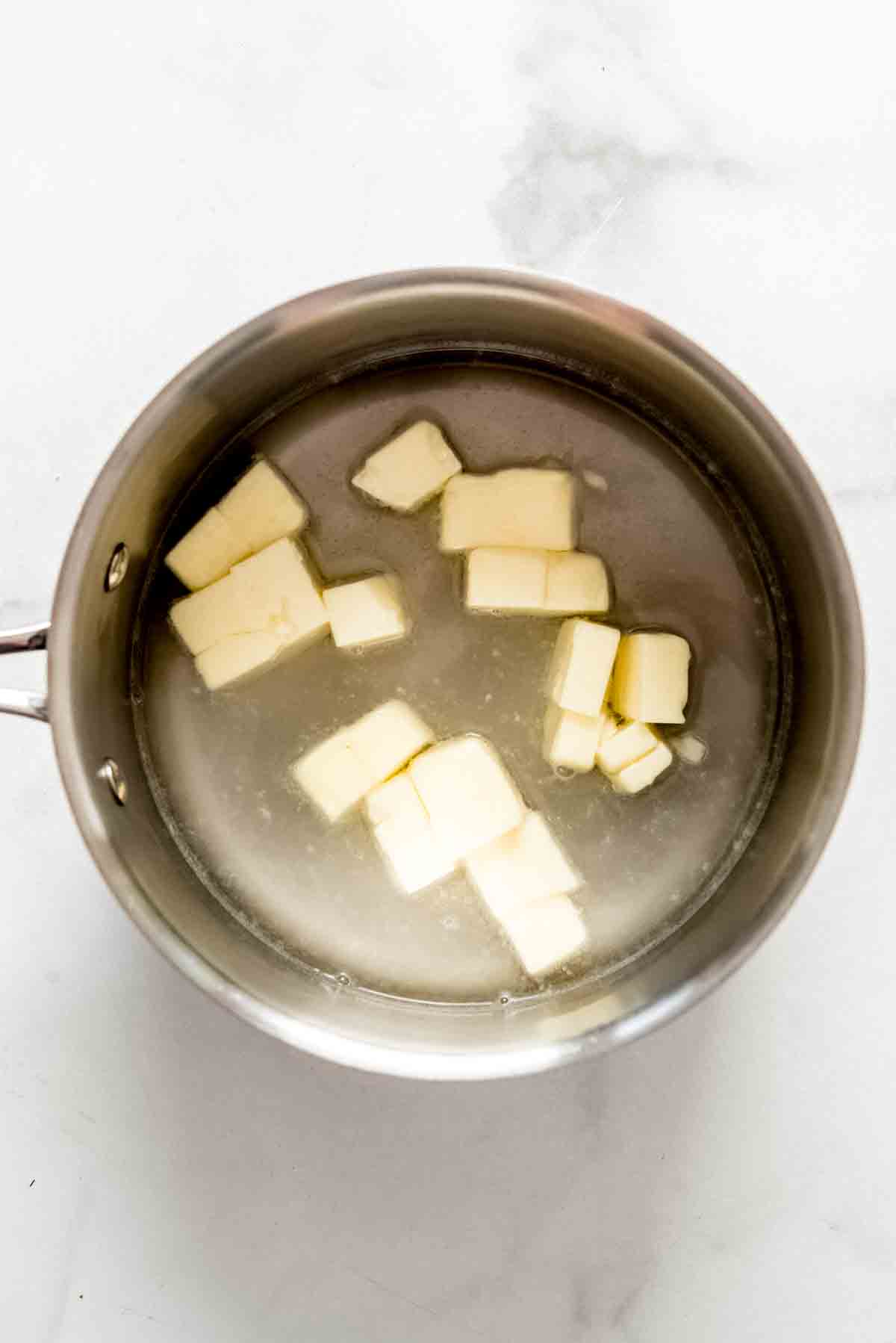 Combining butter and water in a saucepan.