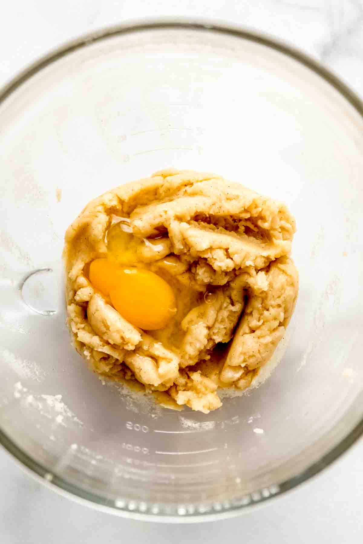 Adding eggs to churro dough.