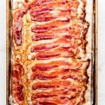 Cooked bacon on a baking sheet lined with foil