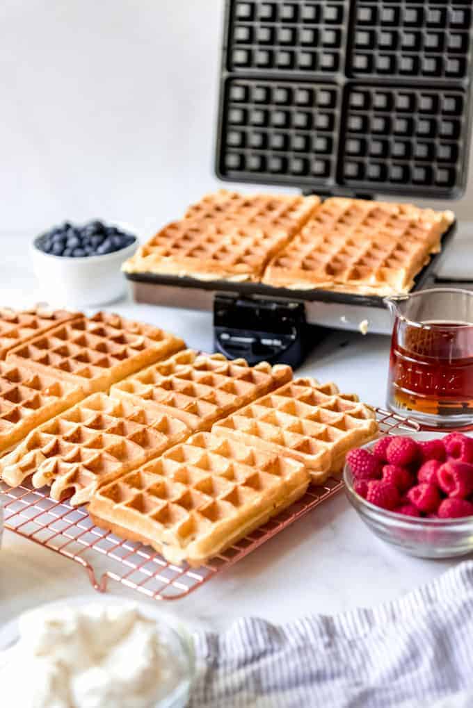 An image of waffles being cooked in a waffle iron.