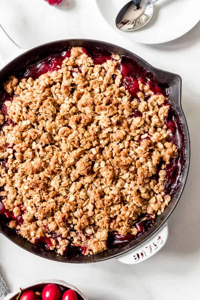 Cherry crisp made in a large cast iron skillet.