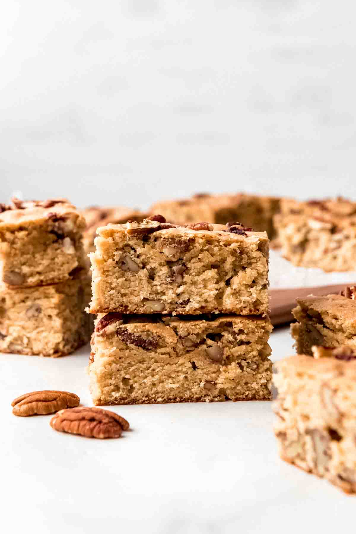 Maple pecan blondies stacked on top of each other.