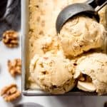 Homemade maple walnut ice cream scooped into balls in a bread pan.