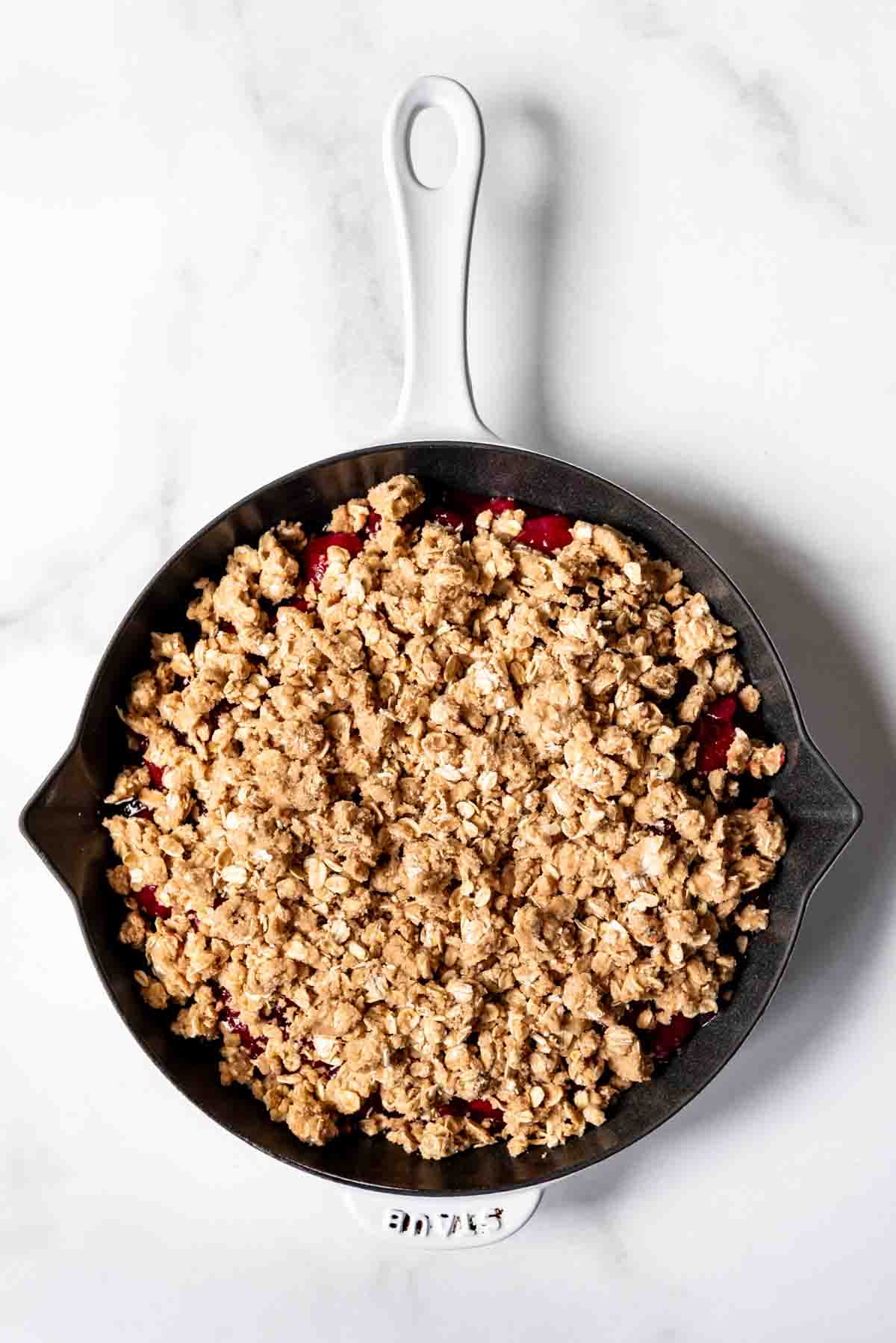 A cherry crisp in a pan ready to go in the oven.