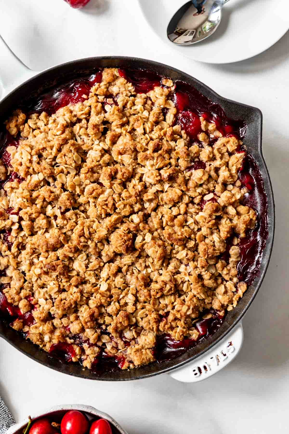 Cherry crisp made in a large cast iron skillet.