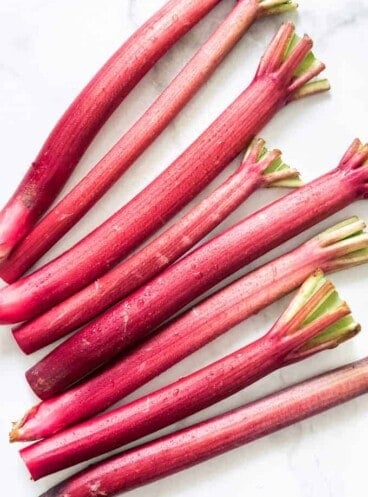 Fresh rhubarb stalks with drops of water on them.