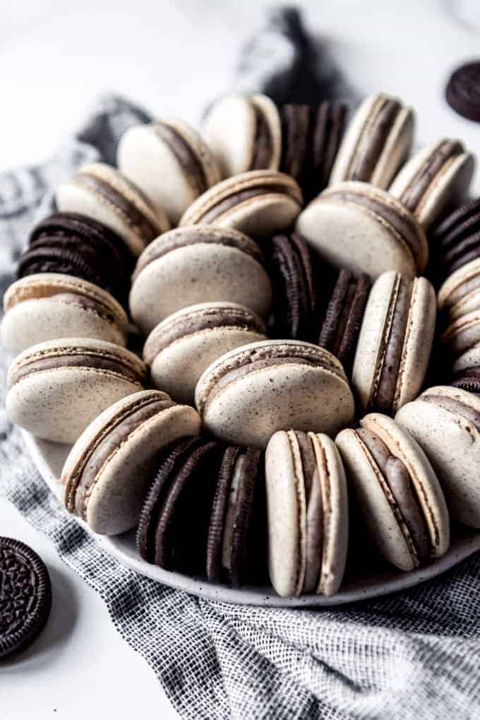 Cookies and cream macarons on a plate with Oreos.