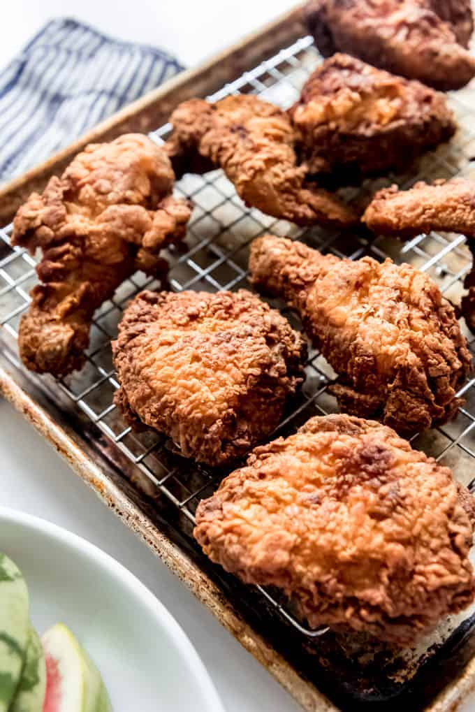 Pieces of fried chicken on a baking sheet.