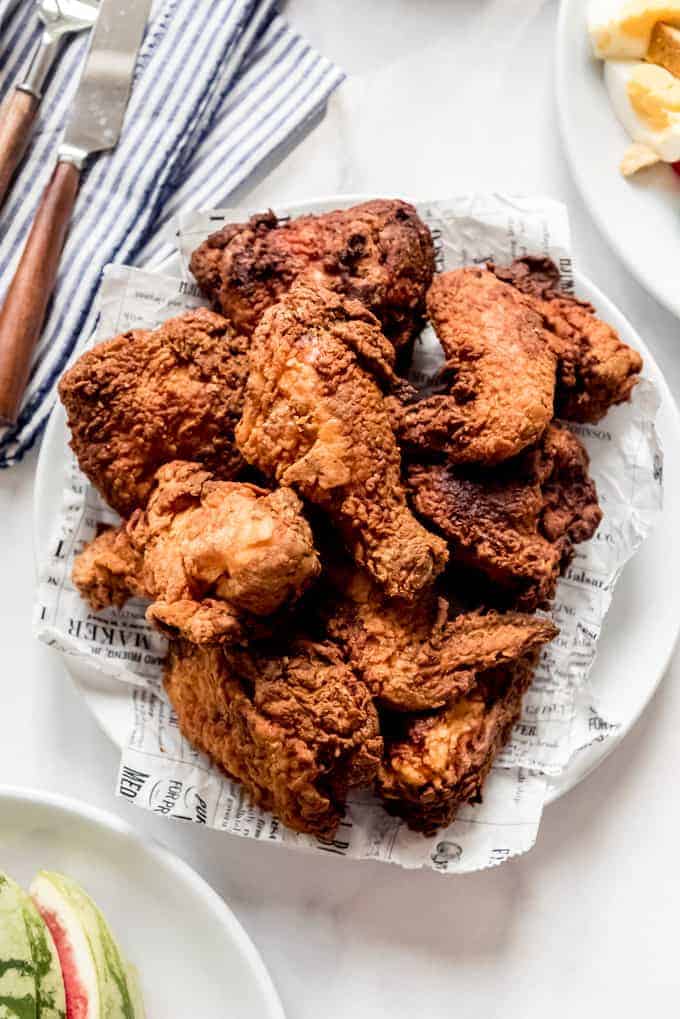 Fried chicken piled on a white plate.