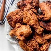 A close image of pieces of fried chicken on a plate.