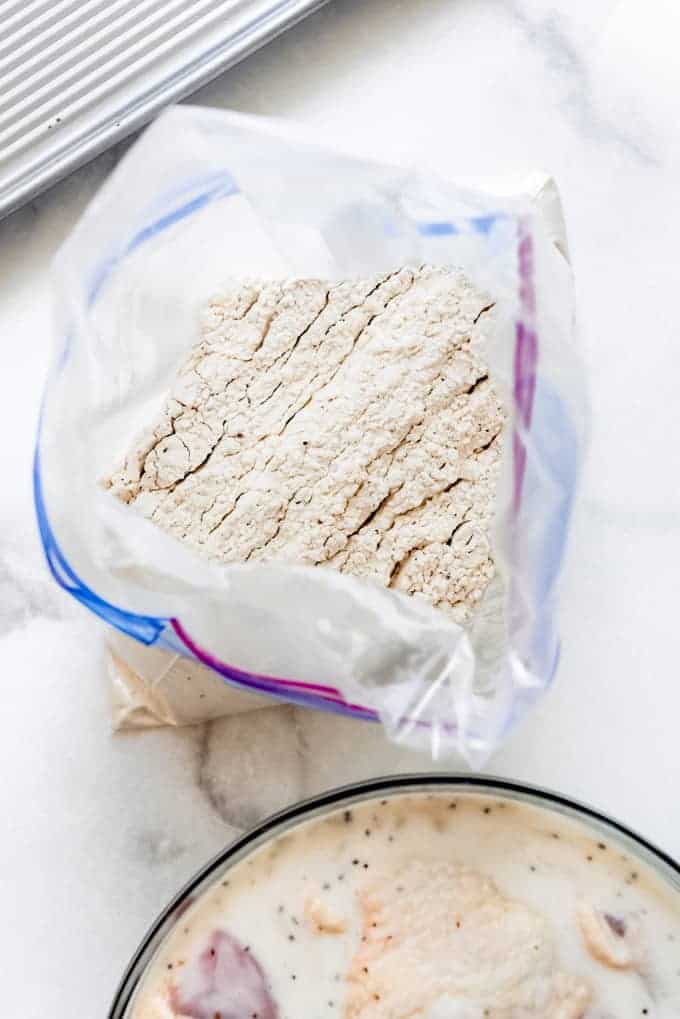 A plastic zip tight bag filled with seasoned flour.