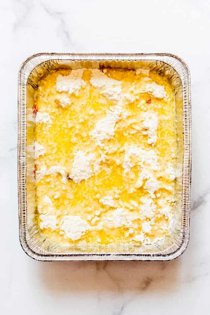Melted butter over cake in disposable pan