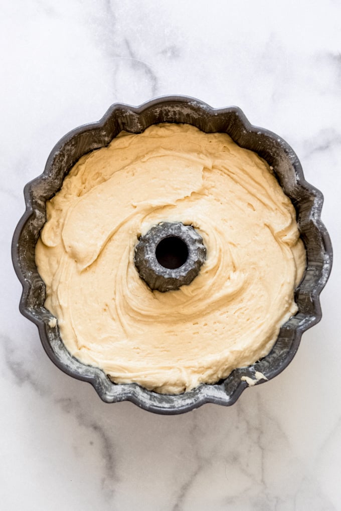 Cake batter inside a prepared bundt pan