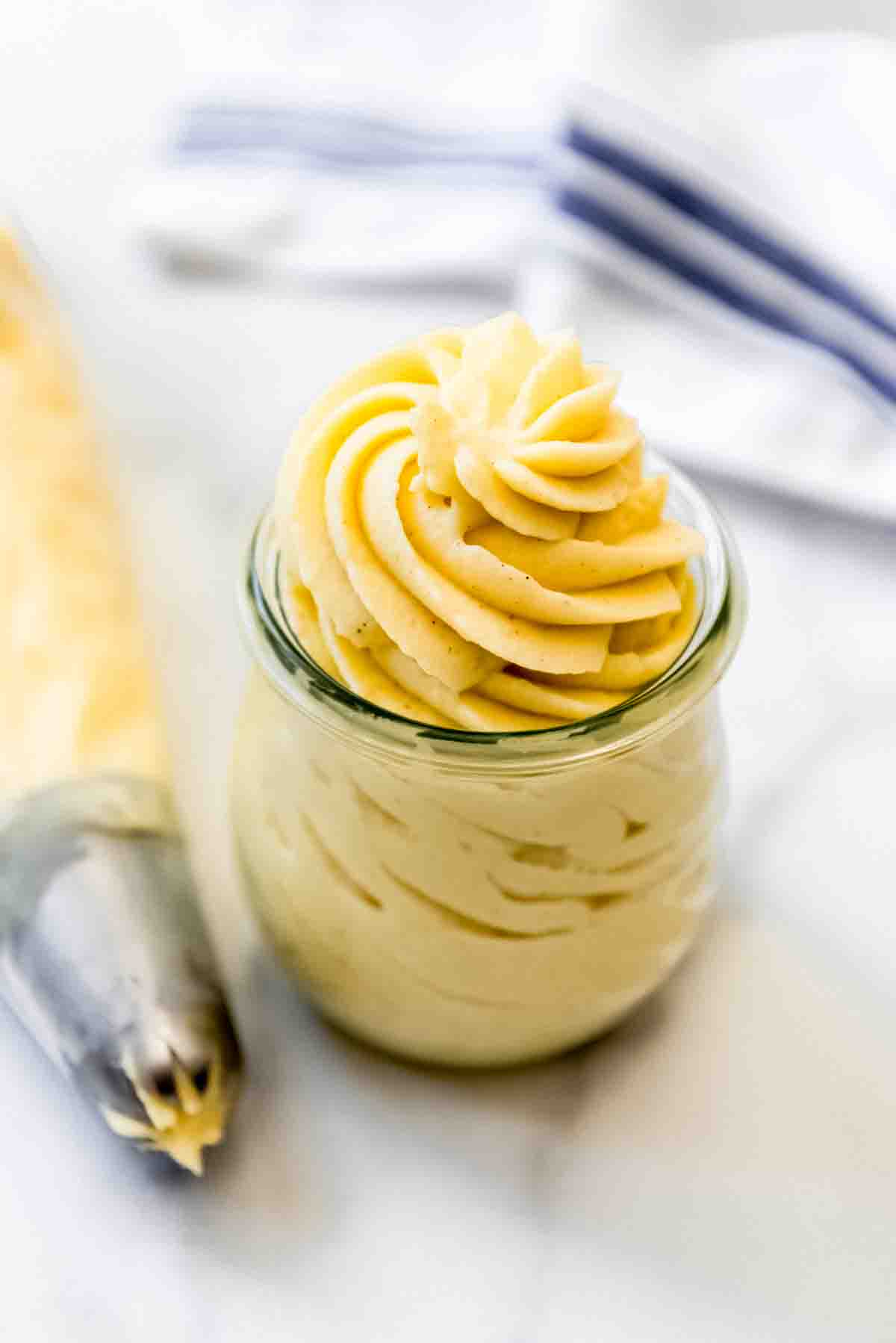 Swirls of vanilla pastry cream in a glass jar.