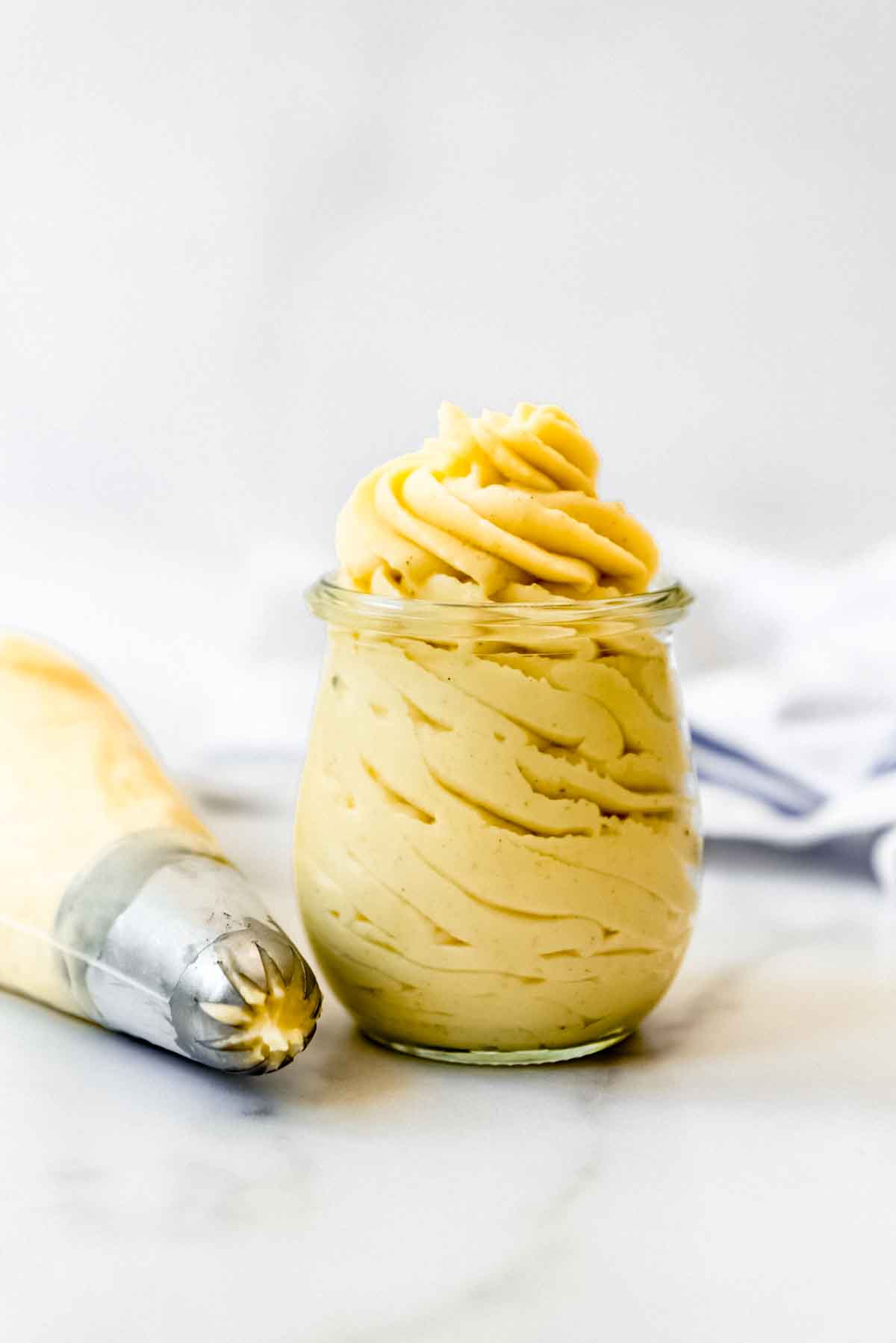 A glass jar filled with French pastry cream.