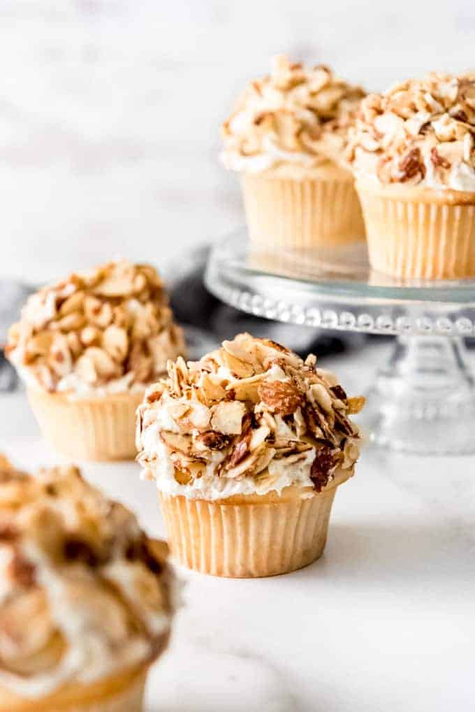 Cupcakes covered in frosting and almonds.