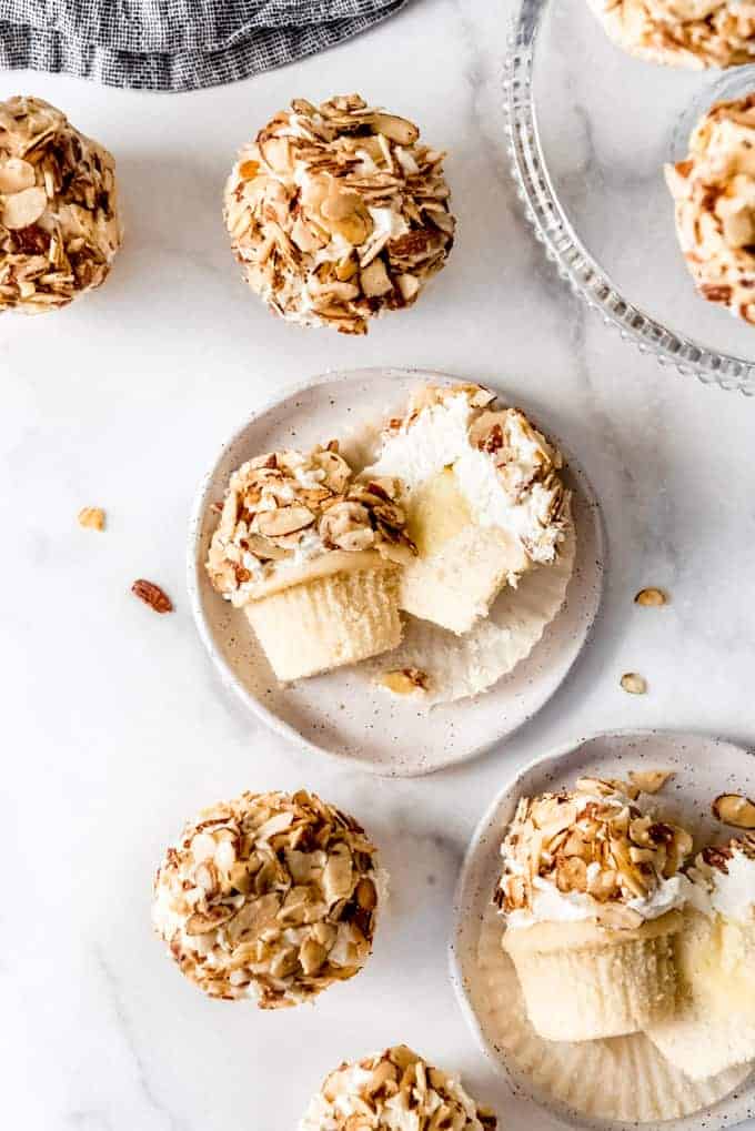 A burnt almond cupcake sliced in half on a plate.