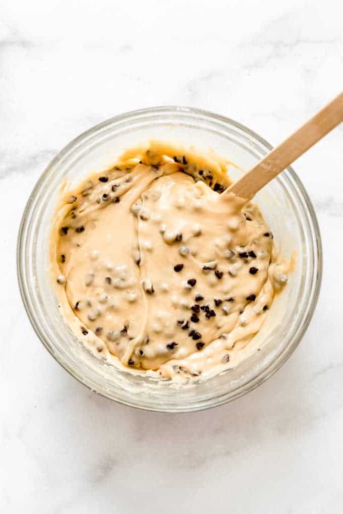 a bowl of chocolate chip cookie dough fudge with a spoon stuck inside