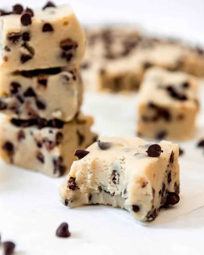 A piece of cookie dough fudge with a bite taken out of it.