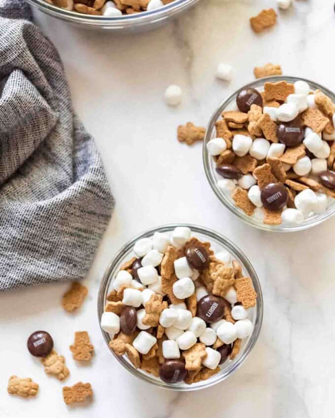 Individual serving bowls of s'mores snack mix.