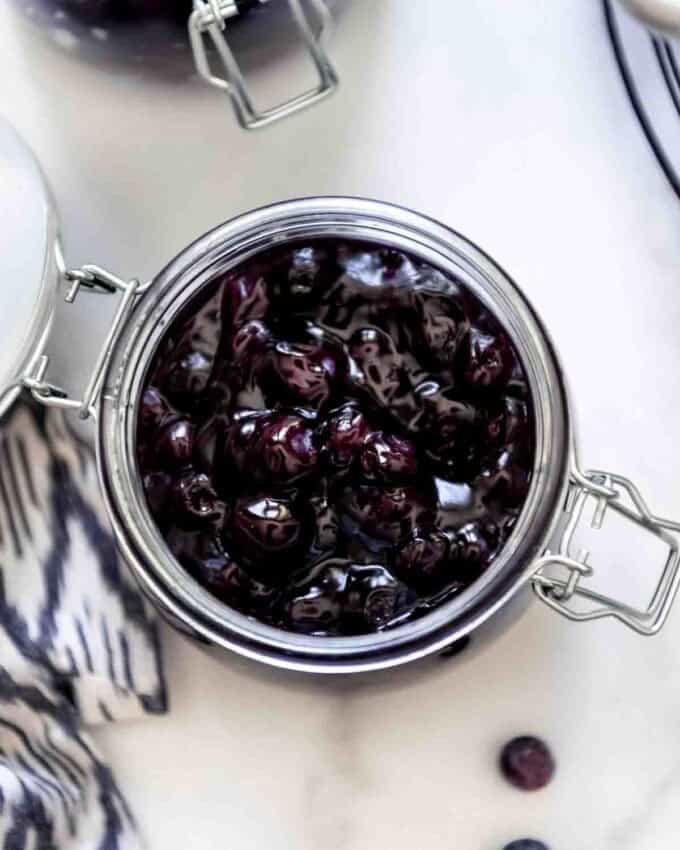 An overhead image of a jar of homemade blueberry pie filling.