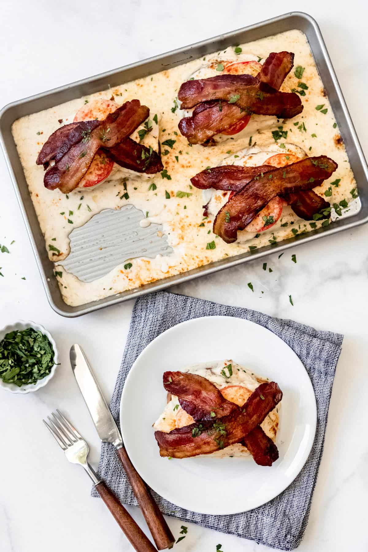 Overhead view of Kentucky hot brown sandwiches on sheet pan and plate.