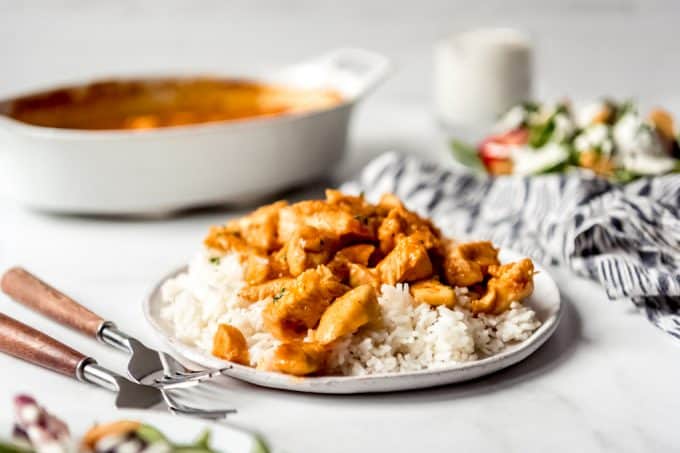 Pieces of saucy chicken over white rice.