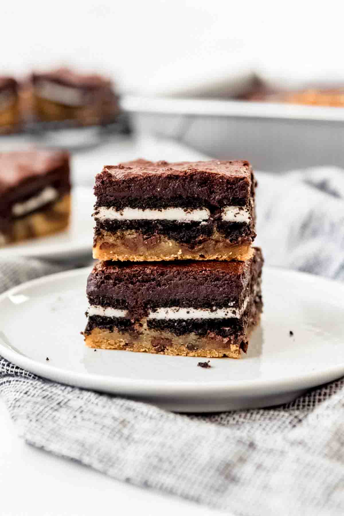 Slutty brownies stacked on a white plate.