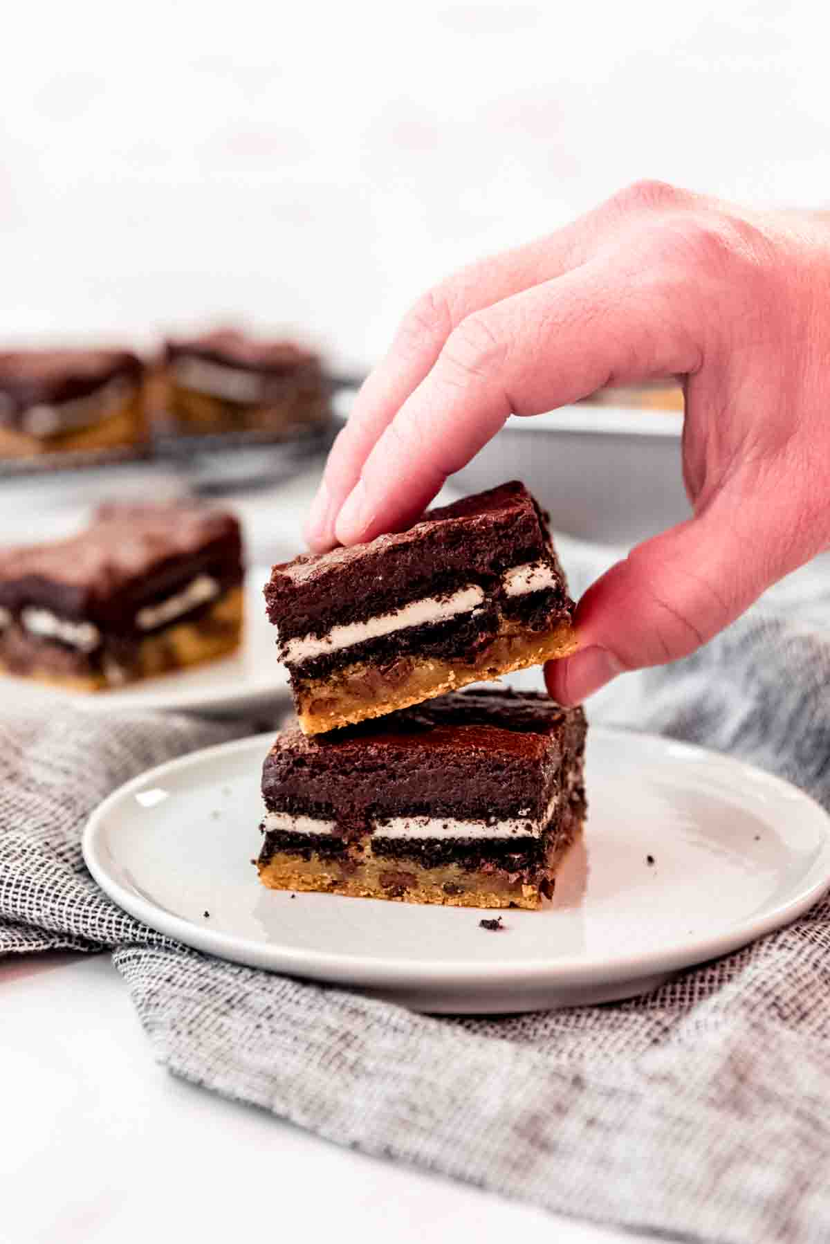 A hand picking up a slutty brownie.