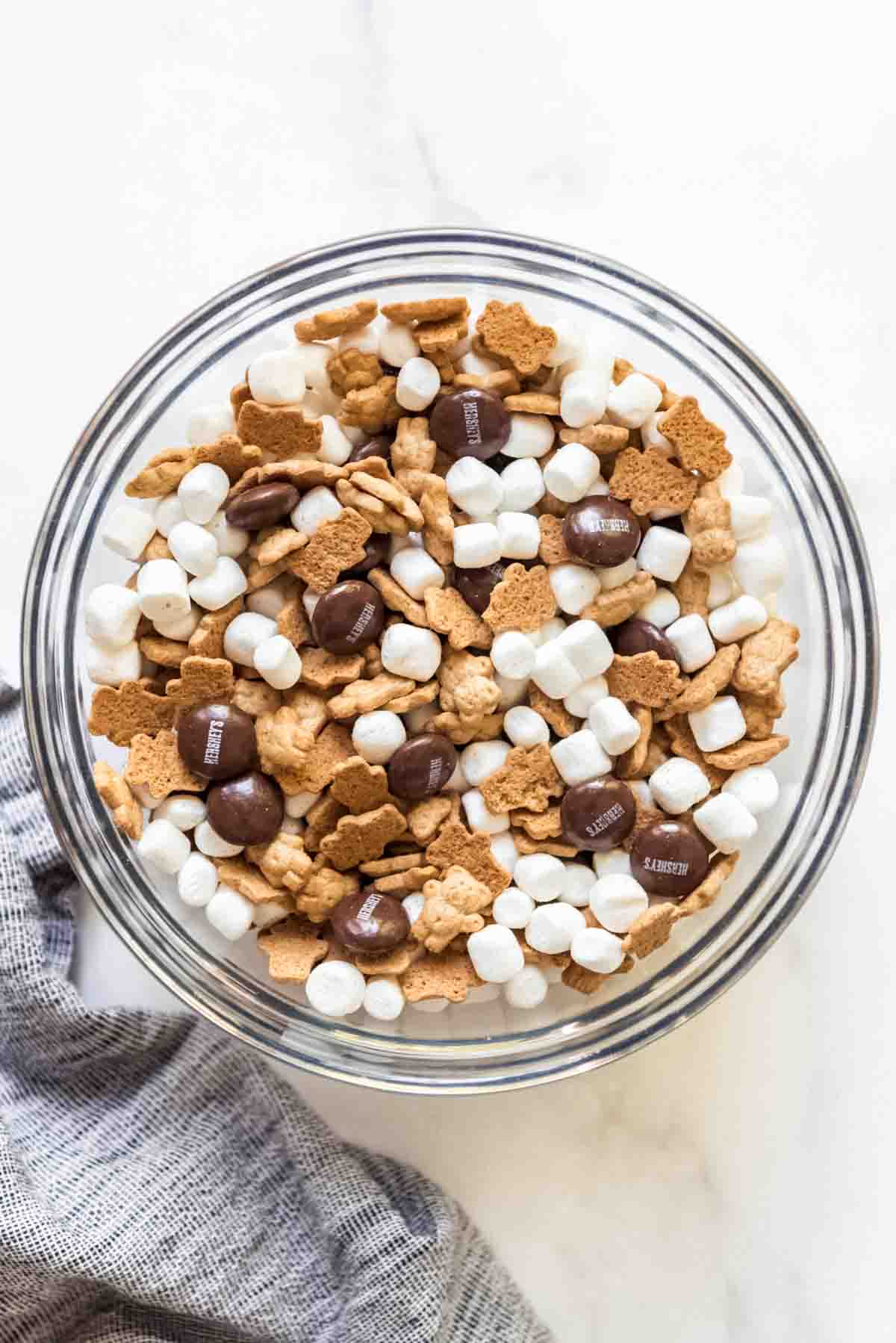 A large bowl filled with Teddy Grahams, marshmallows, and Hershey's chocolate drops.