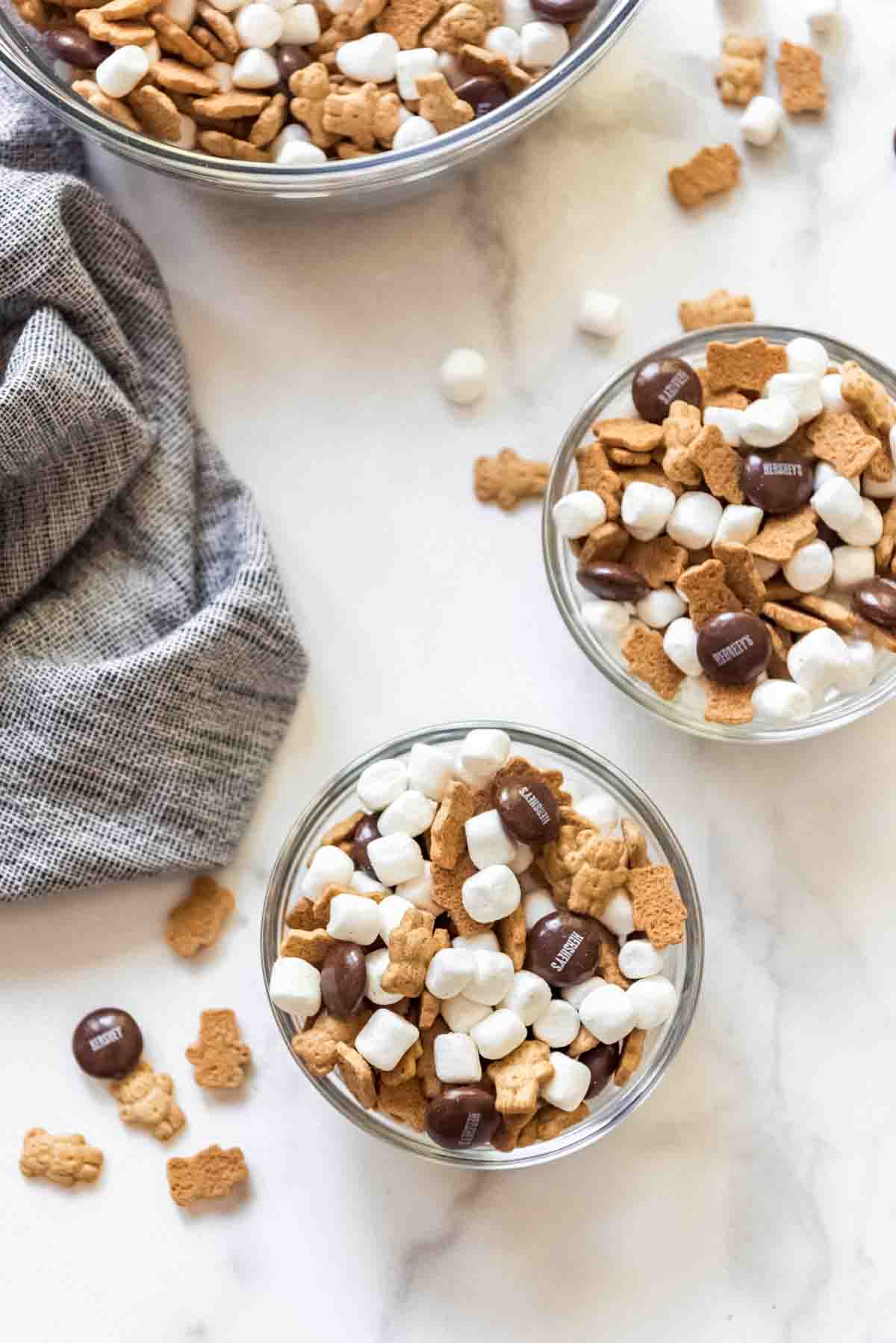 Individual serving bowls of s'mores snack mix.