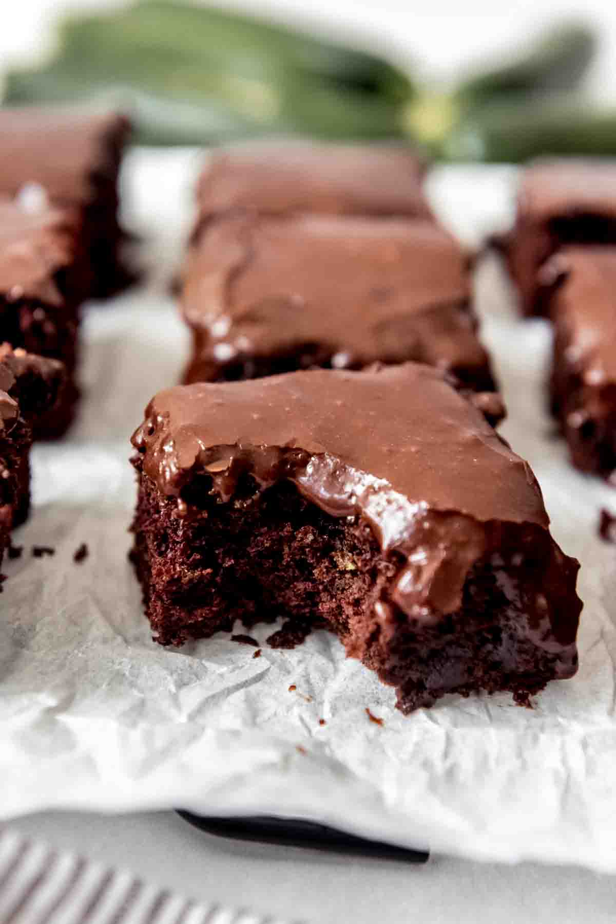 A zucchini brownie with a bite taken out of it.