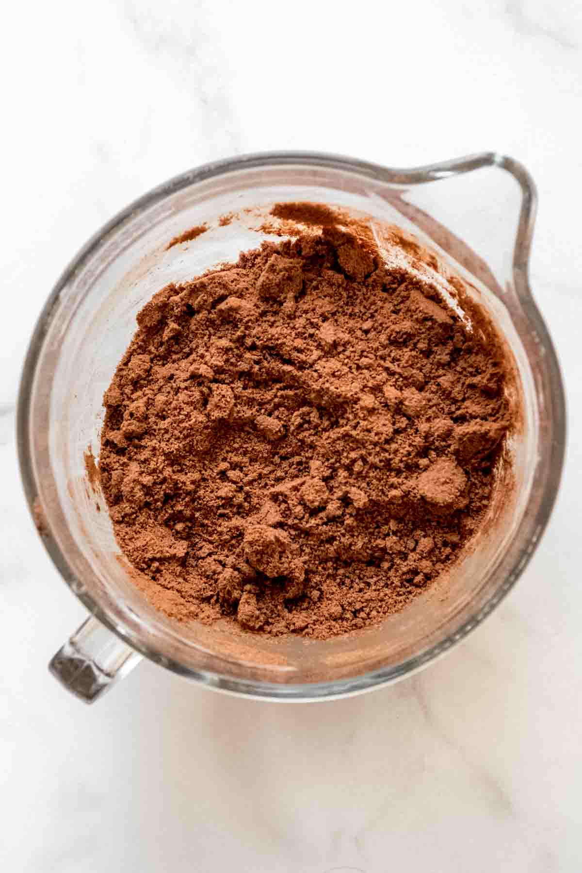 An overhead view of a bowl filled with dry looking ingredients for zucchini brownies.