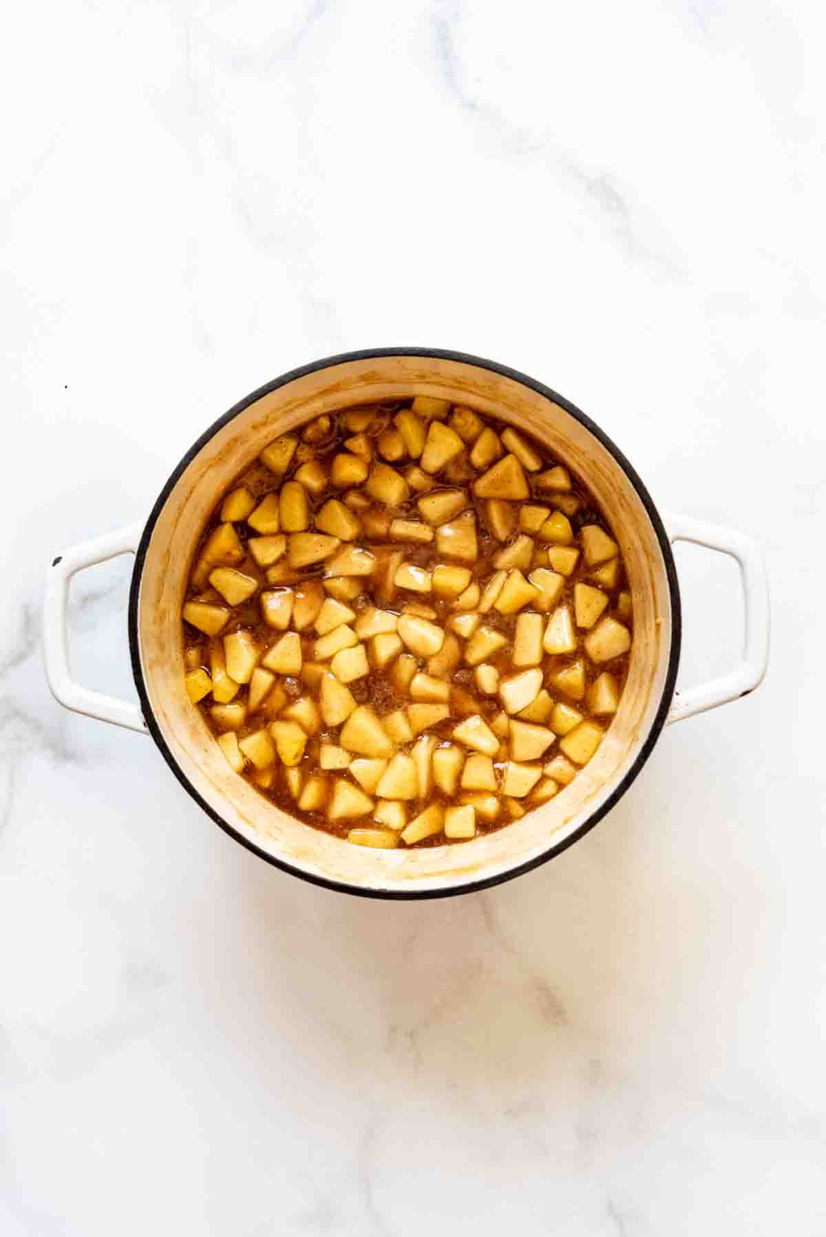 A large pot filled with apple pie filling.