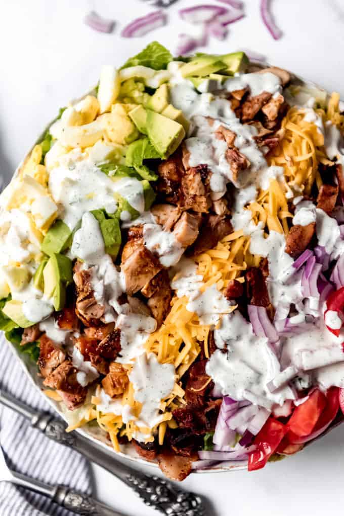 Ranch dressing drizzled over a chicken cobb salad.