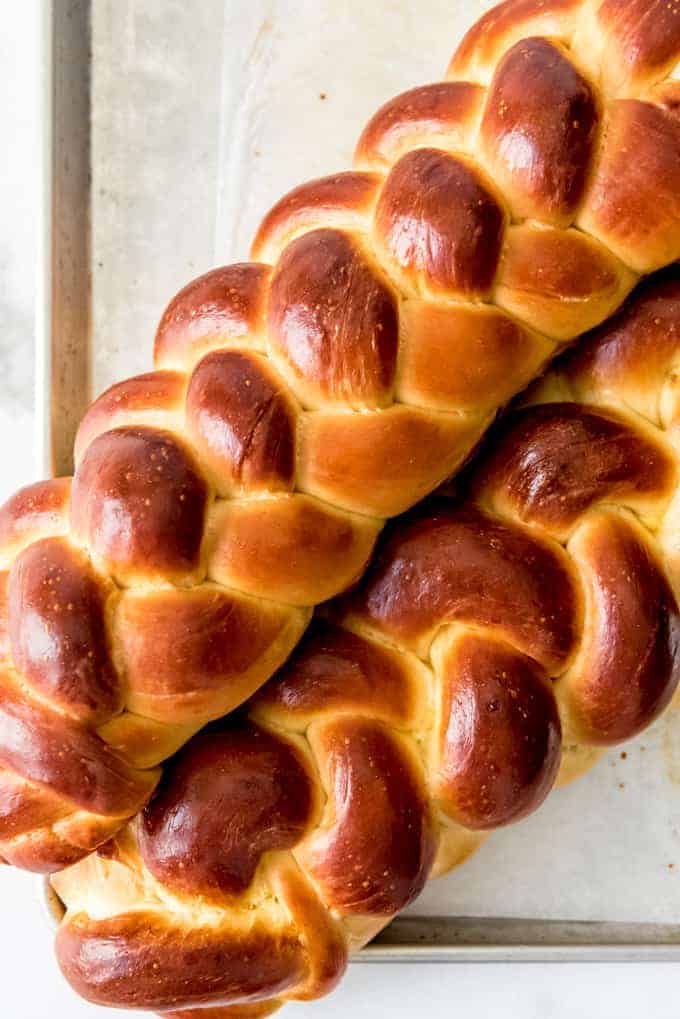 A close image of braided challah bread loaves.