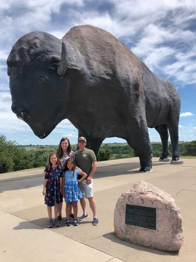 A family in front of the World's Largest Buffalo in Jamestown, North Dakota.