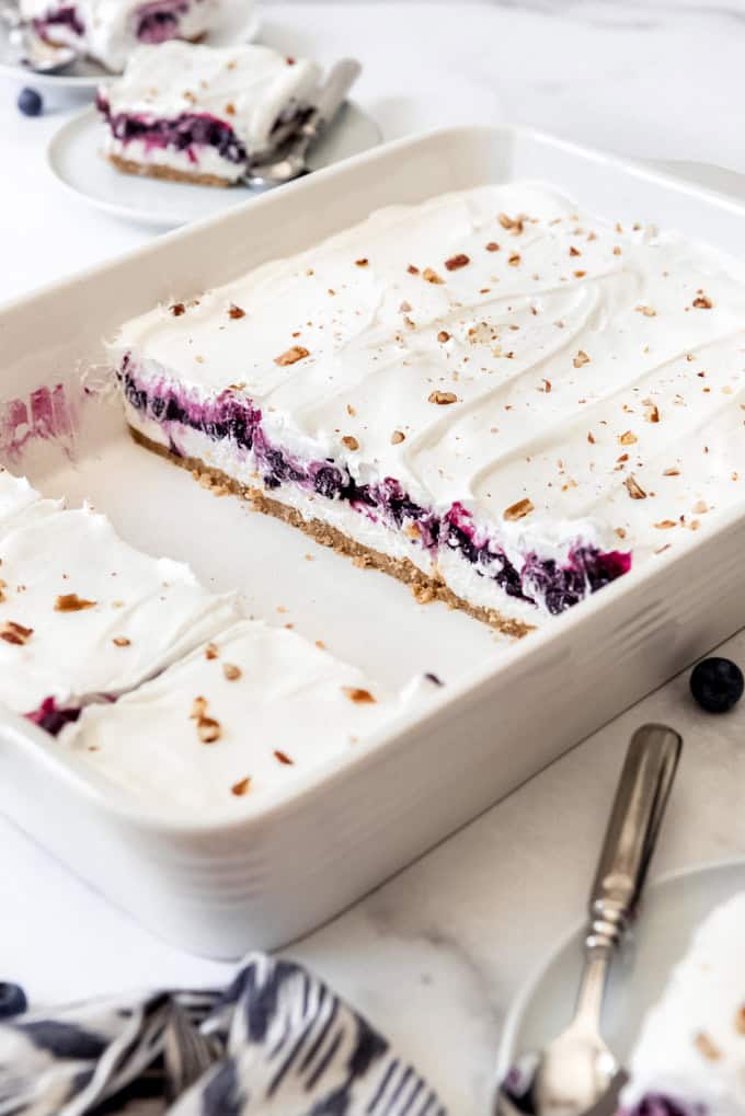 A cross-section showcasing layers of blueberry filling and no-bake cream cheese filling in blueberry delight.