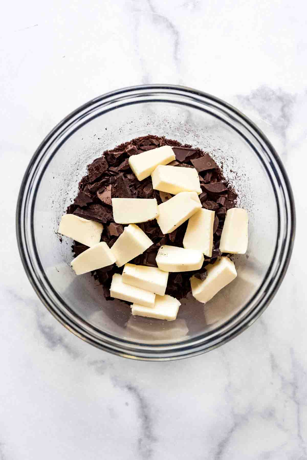 A bowl of chocolate and butter about to be melted together.